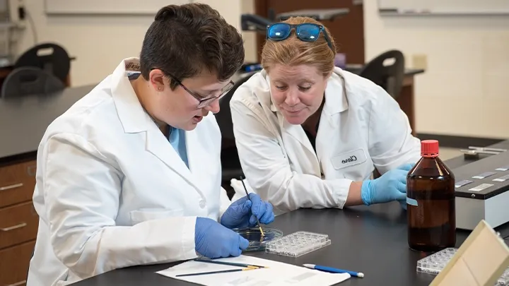 BW professor mentoring student in biology lab research